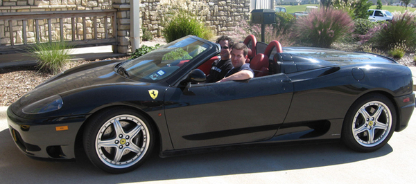 Drive Your Dream Tour participants cruise in a black Ferrari 360 Spider